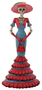 Day of the Dead Lady Isabela. Red hat, long blue and red dress with ruffles on the bottom.