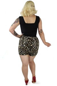 Model wearing leopard high waisted shorts back side