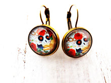 Load image into Gallery viewer, Day of the Dead Skull and Roses Drop Earrings. These earrings feature images of Day of the Dead inspired skulls and roses.