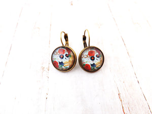 Day of the Dead Skull and Roses Drop Earrings. These earrings feature images of Day of the Dead inspired skulls and roses.